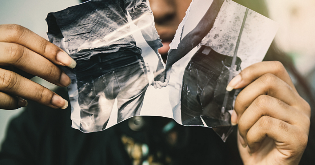 Woman ripping up photo or her and her partner.