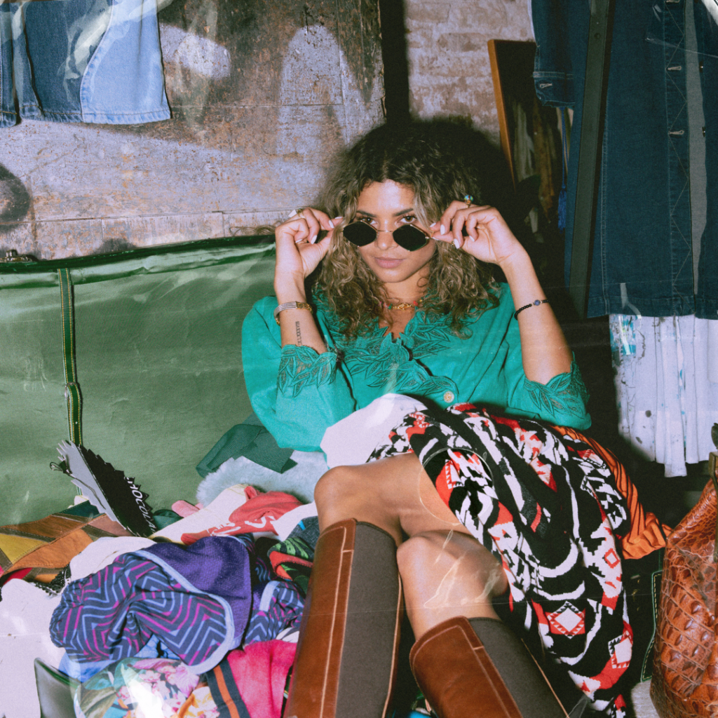 woman looking at the camera smiling pulling her glasses down