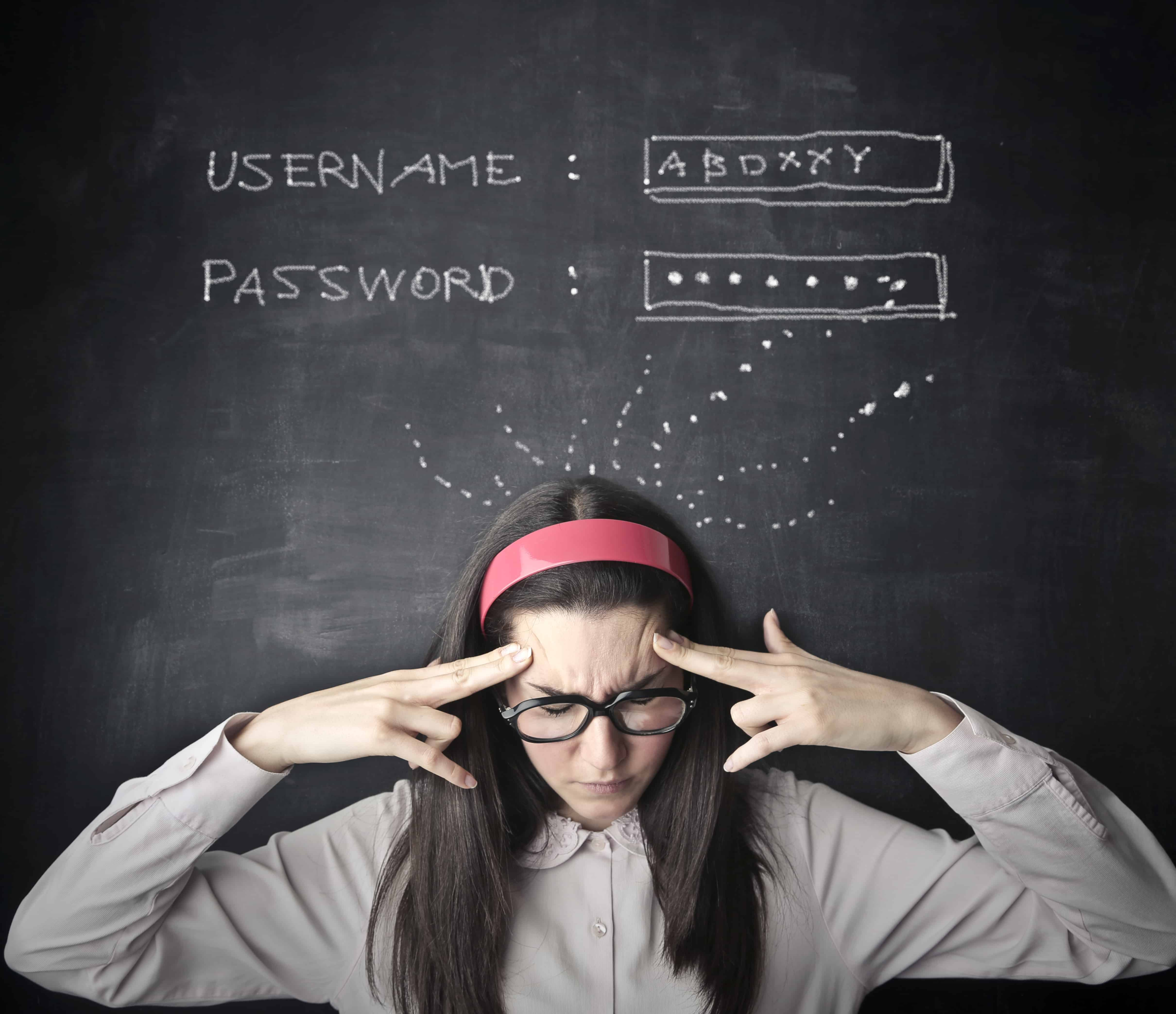 a woman standing at a chalk board fully present thinking about things.