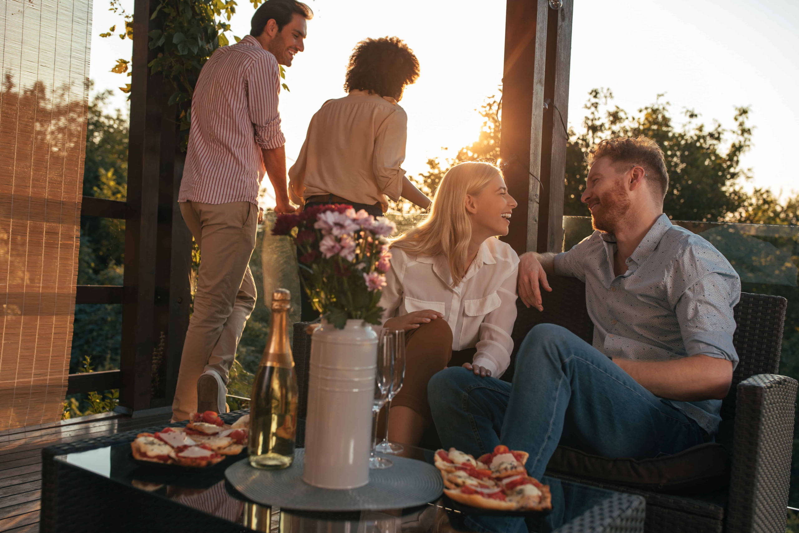 A young couple in a long term relationship sitting with each other outside enjoying wine and drinks. They started as friends with benefits but soon realized that both had feelings for each other.