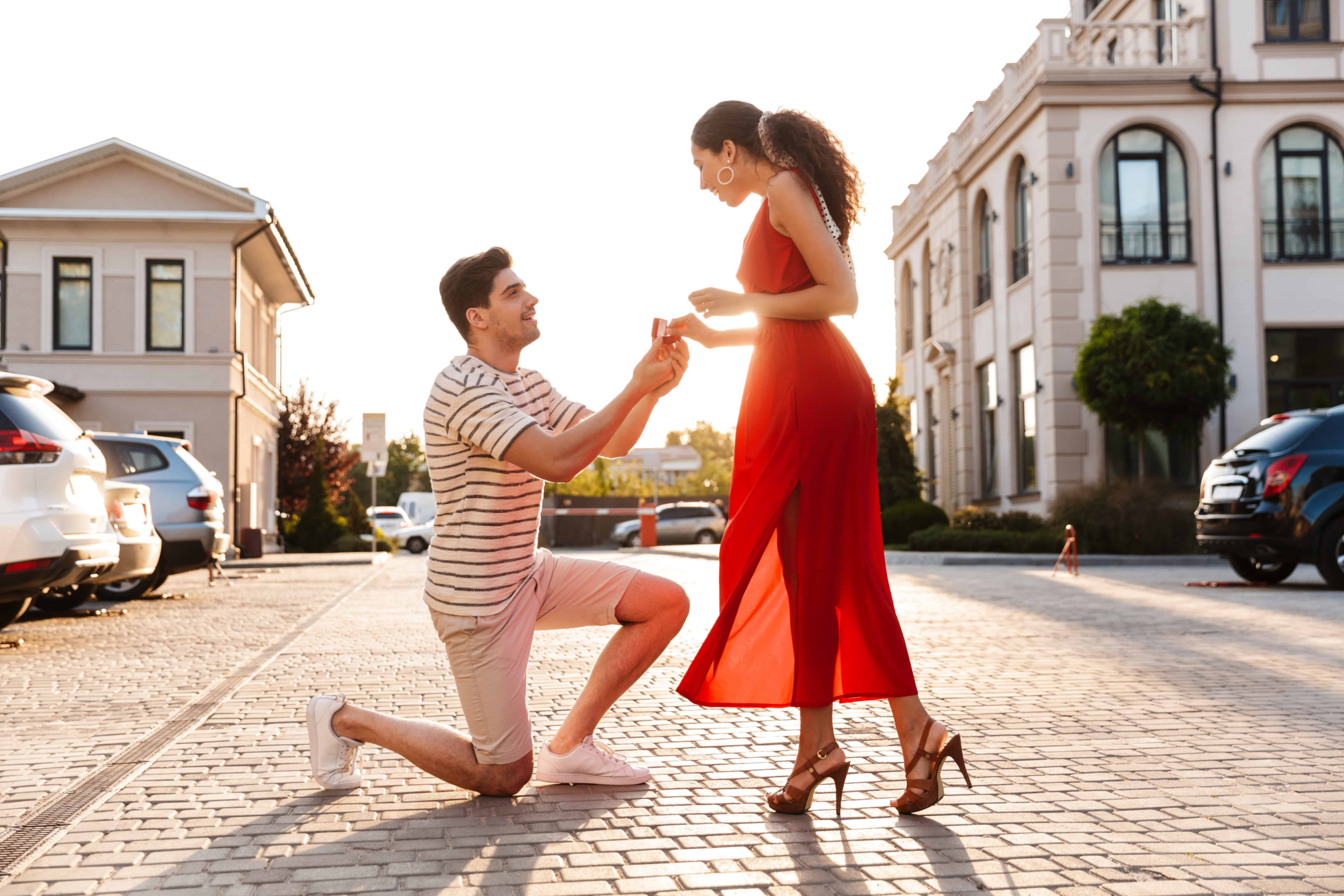 A man down on one knee with a beautiful background. The guy is asking for her hand in marriage. Before she says yes or no she is thinking will this be an unequally yoked marriage?