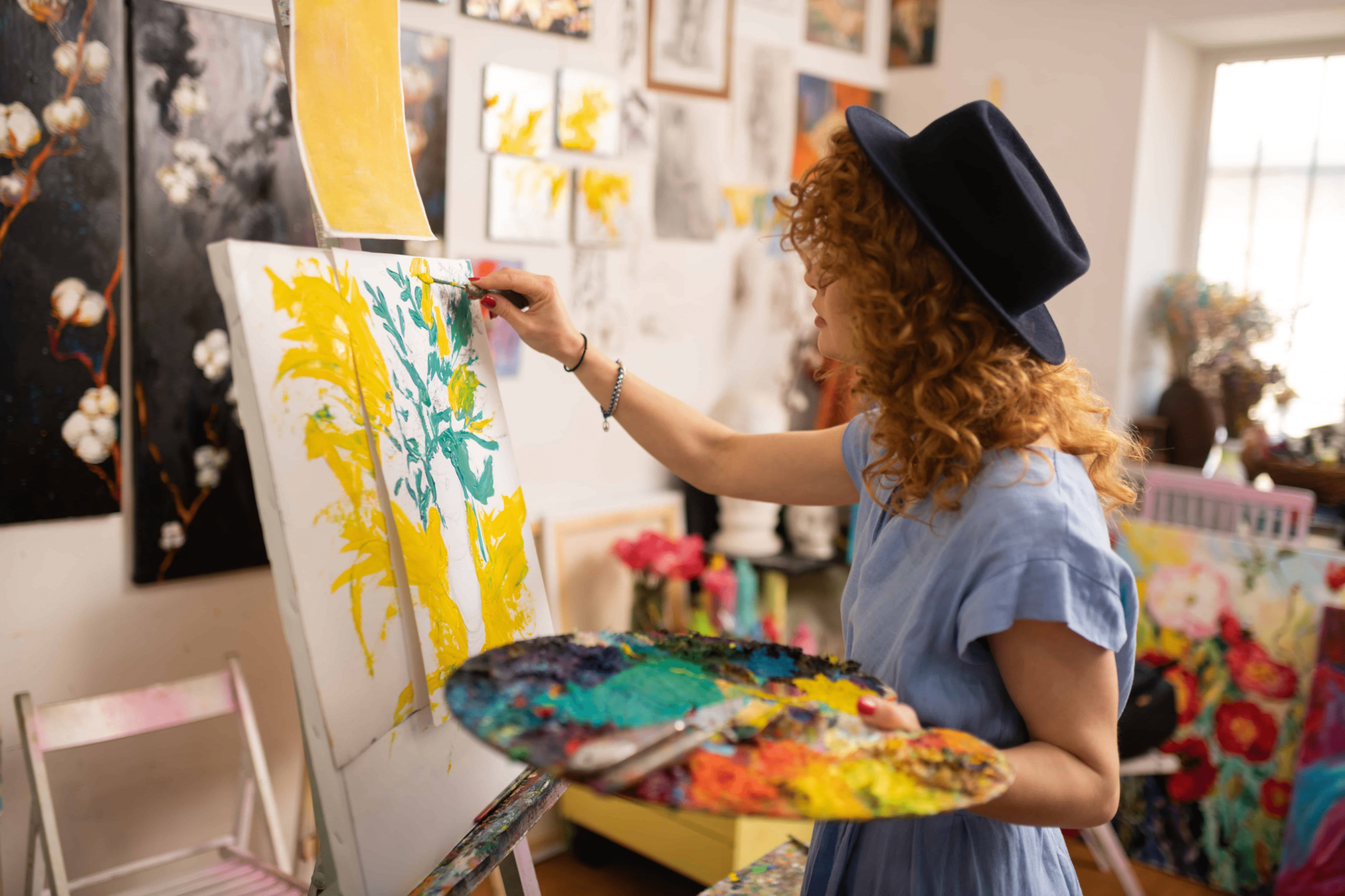 A woman painting with lots of vibrant colors