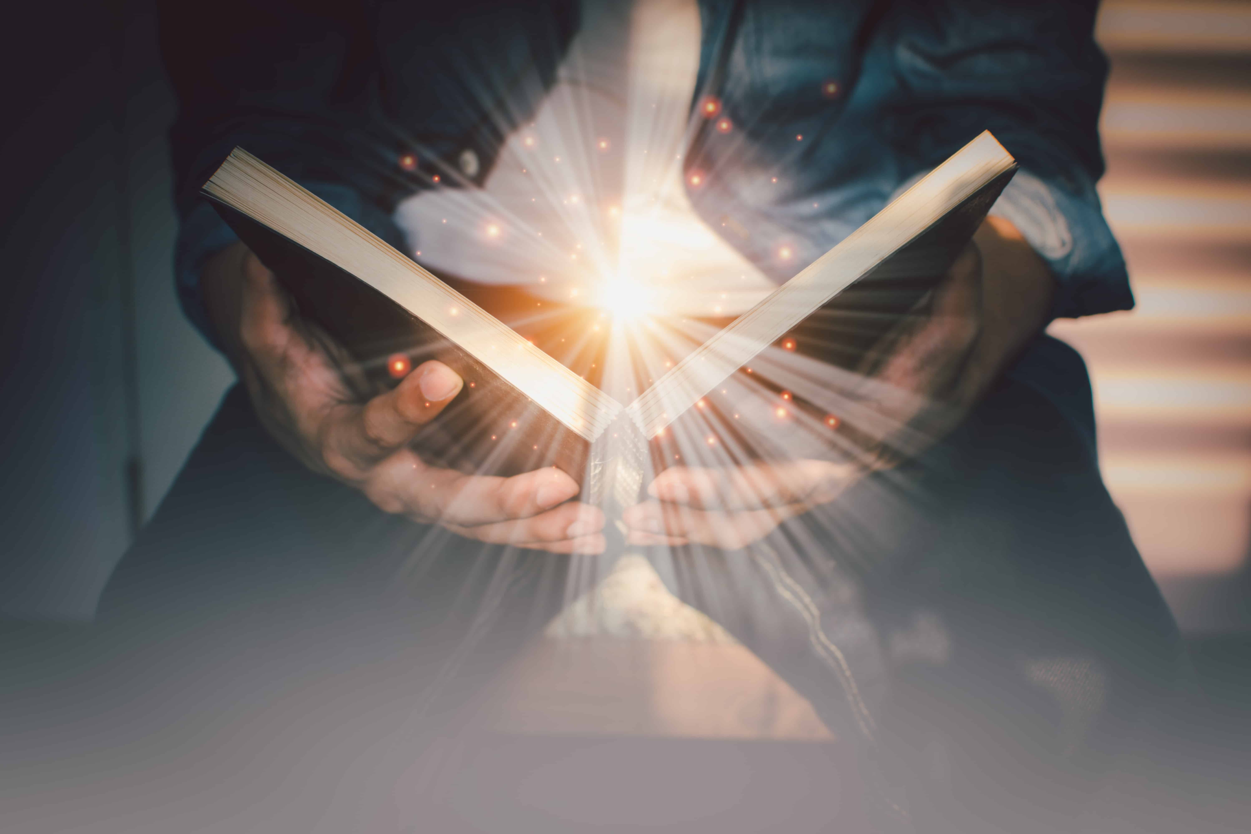 A man opening the bible while at trinity Christian school.