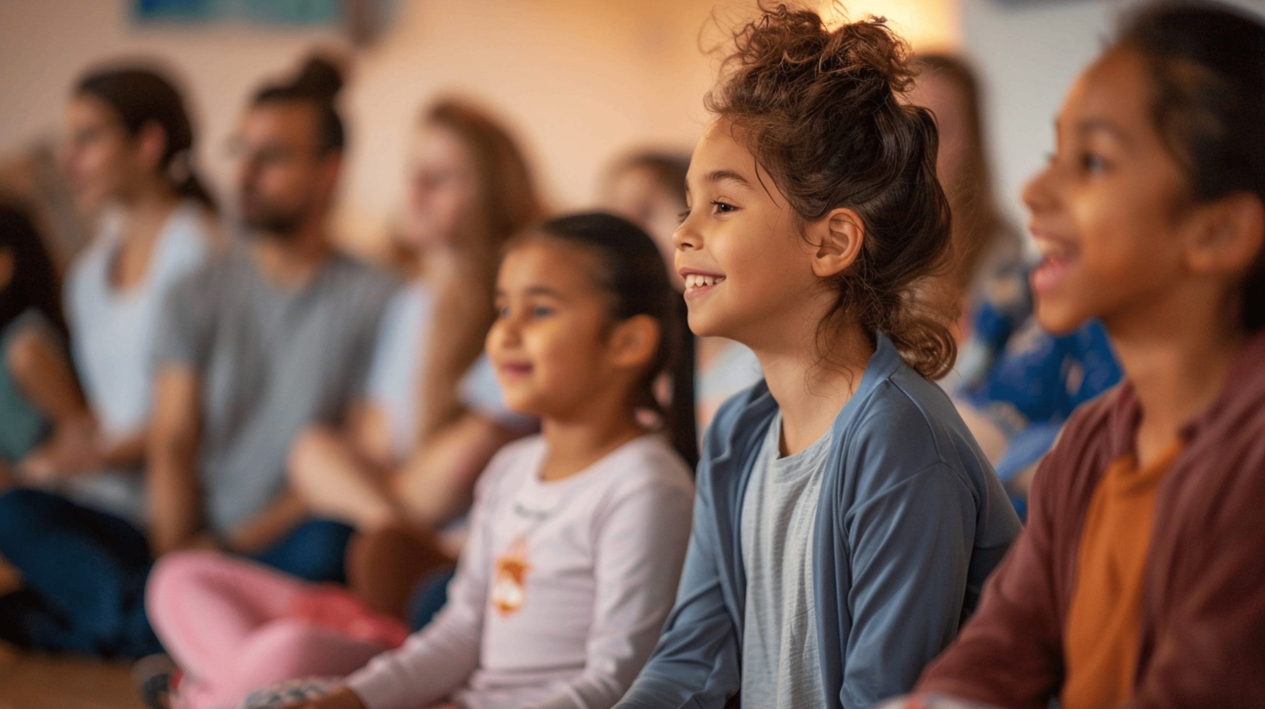A picture of a young boy smiling. He is attending a show that teaches parents how to build self esteem in children. That parent feel proud as they look at their son happy and smiling.