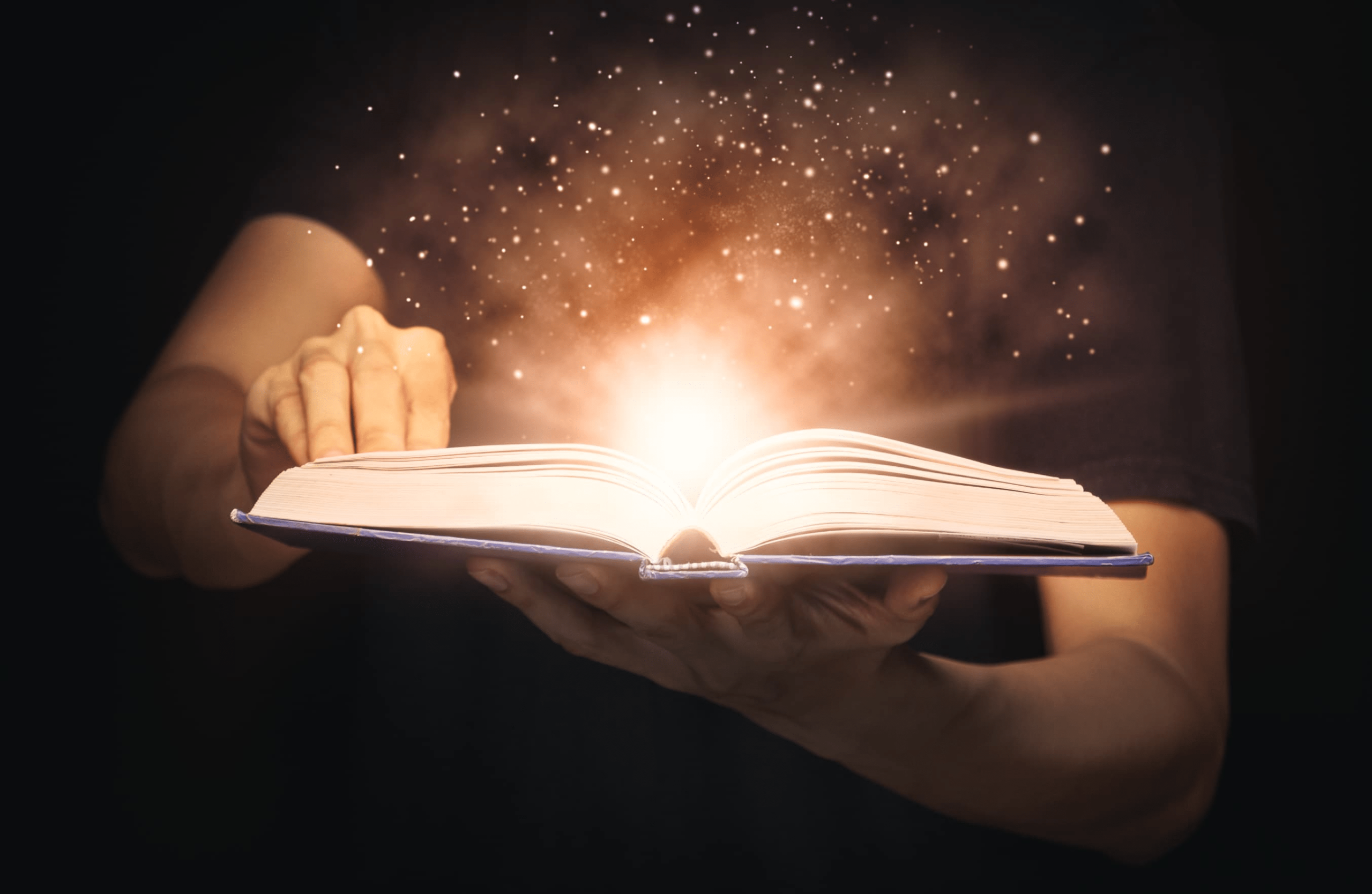 A picture of a bible lighting up as a guy turns the pages.