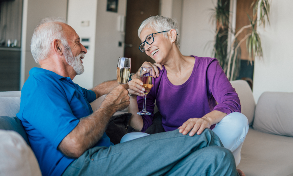a couple sitting on the couch together talking to each other about their day!