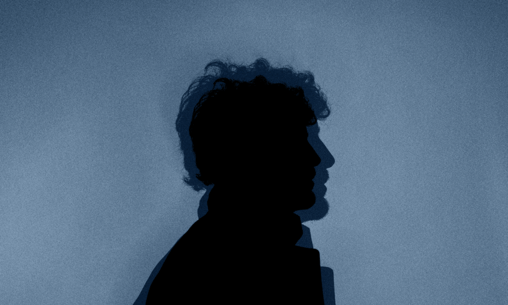 Picture of a guy and his shadow in the background.