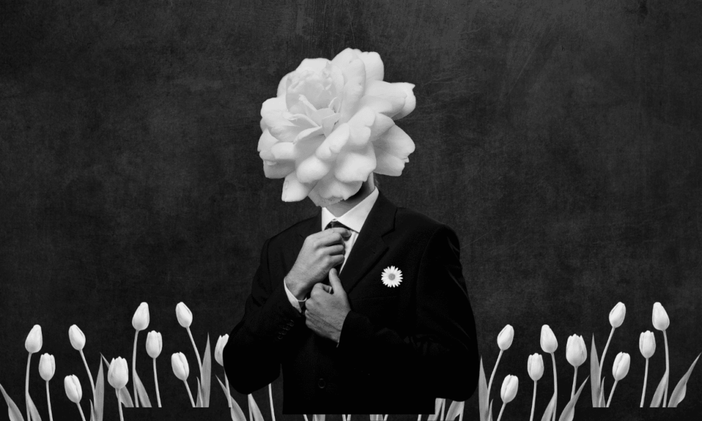A man with a suit and flowers all around him