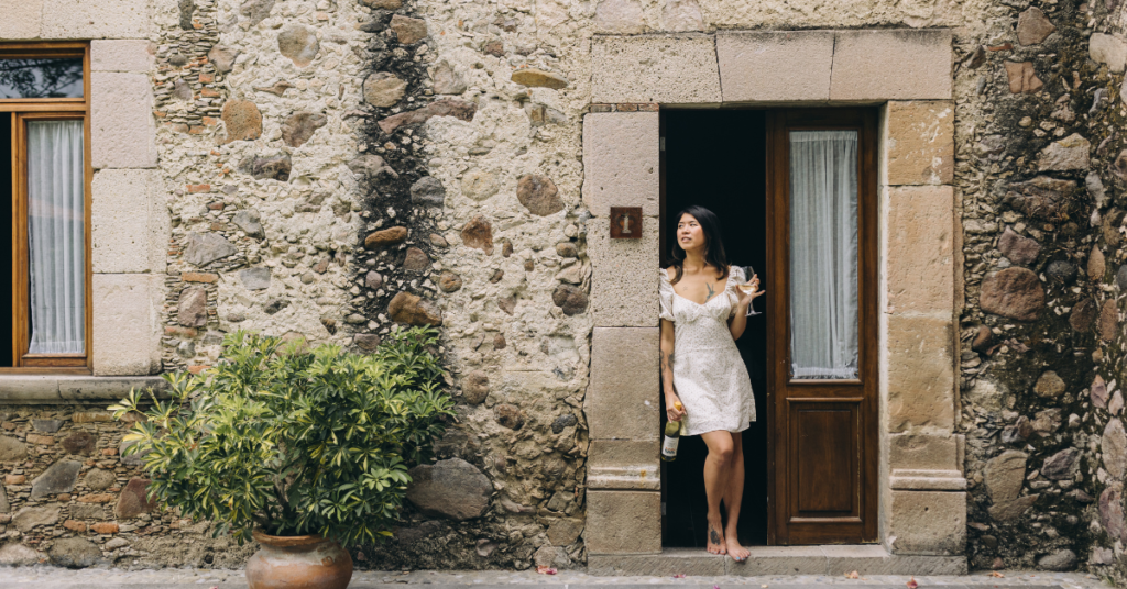 Woman standing outside the doorway lookin into the distance after facing rejection