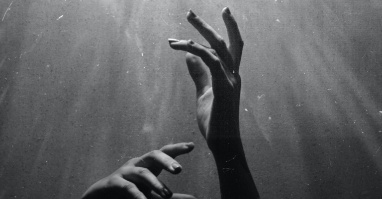 Hands reaching up in the air as if asking for help