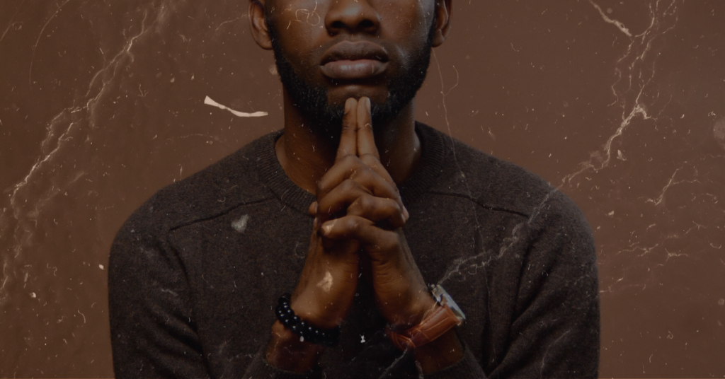 a black man with praying hands